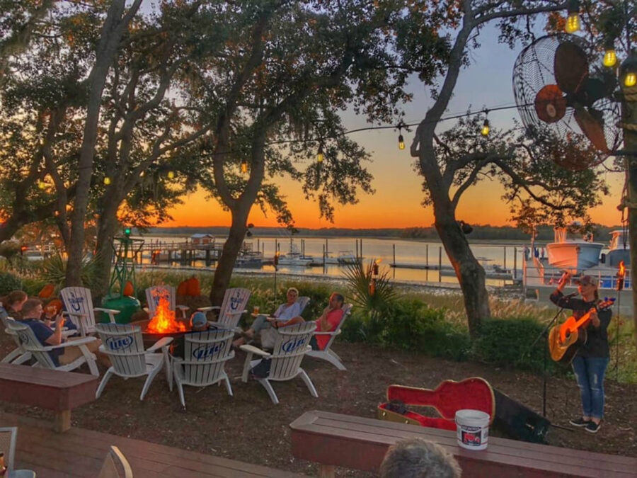 Outdoor seating with a sunset view at Skull Creek Boathouse, Hilton Head Island, creating a serene dining atmosphere.