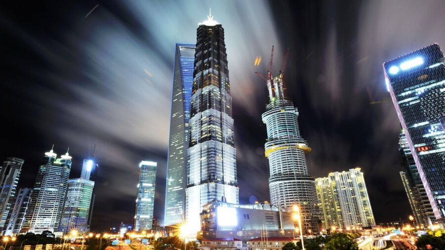 Nighttime Putuo urban skyline with skyscrapers, cranes, and vibrant lighting, showcasing modern architecture.