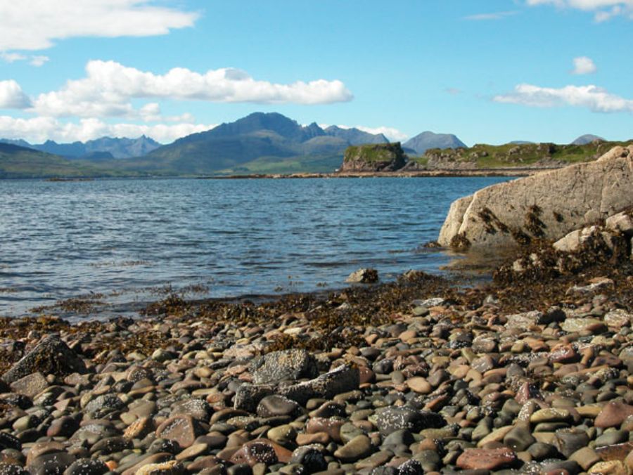 The large body of water at Sleat Peninsula, surrounded by lush greenery and distant hills.
