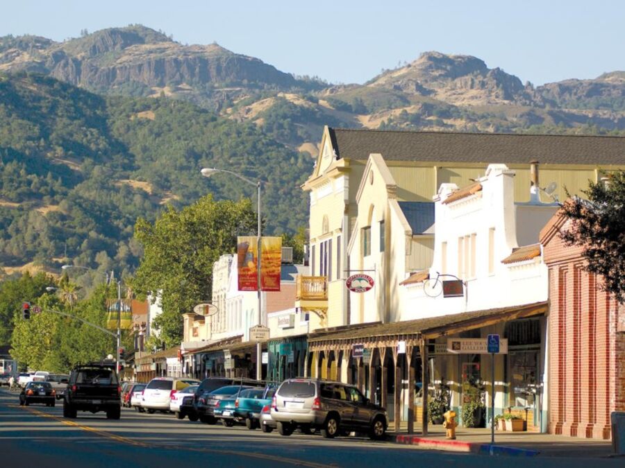 Charming Calistoga small-town street with historic architecture, mountains, local shops, and vibrant community.