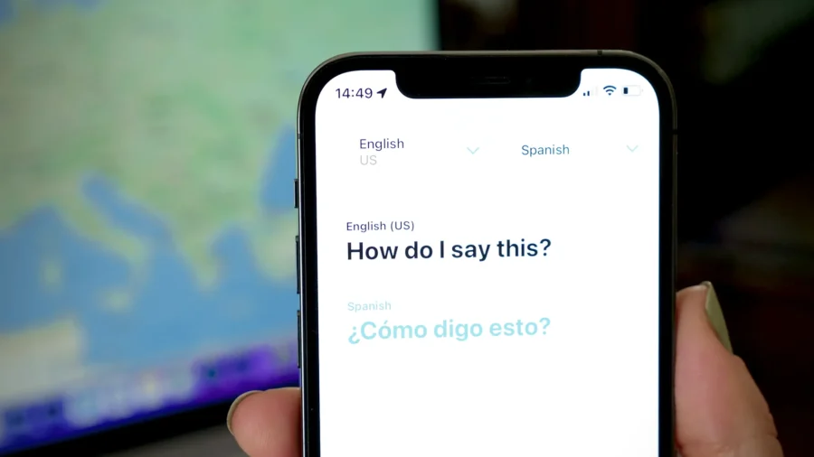 Smartphone with English-Spanish translation app interface, highlighting cross-lingual communication.