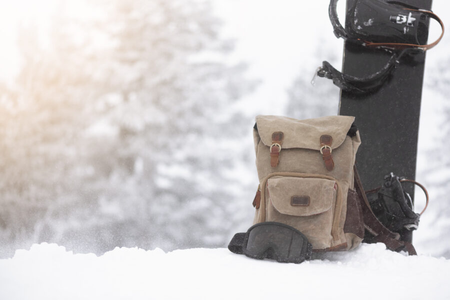 Snowboard gear displayed against a snowy blizzard backdrop, emphasizing a winter sports theme.
