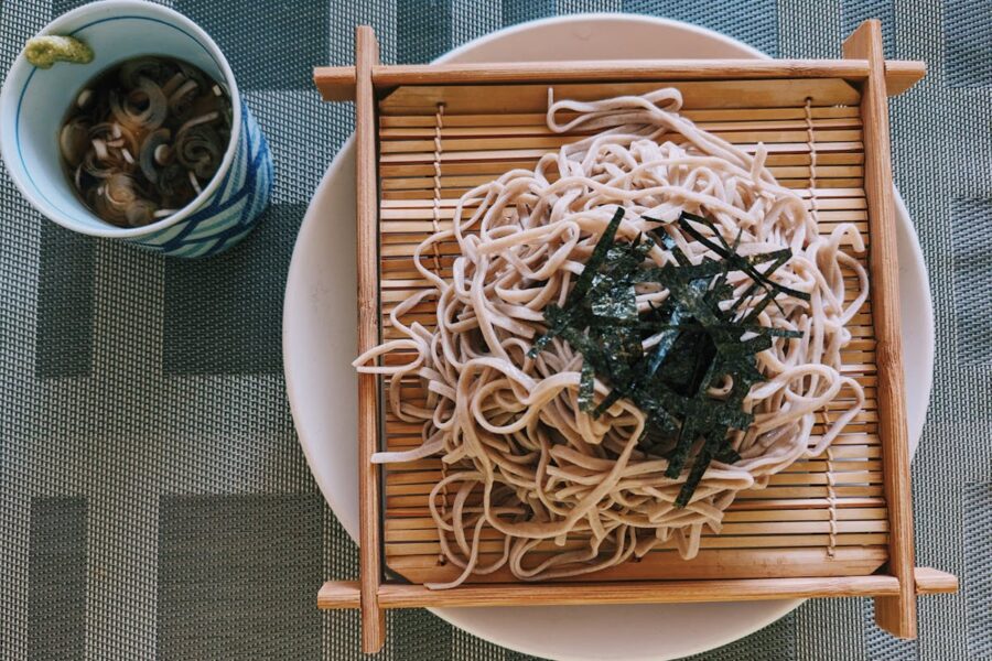 Beautifully presented soba noodles on bamboo mat with tsuyu sauce and wasabi.