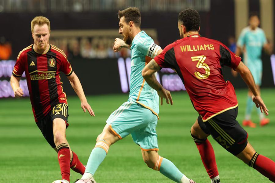 Miami vs. Atlanta United soccer action with key player in blue evading opponents.