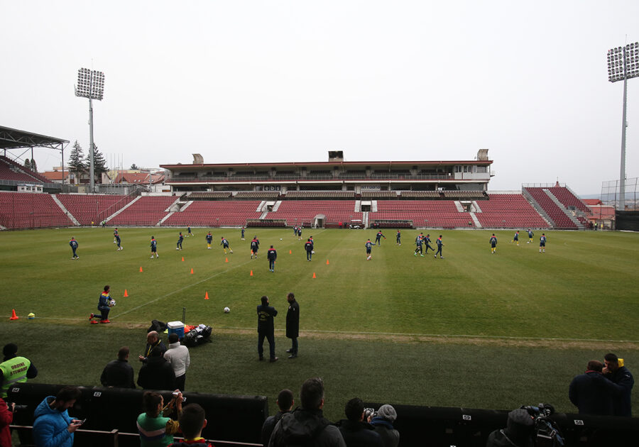 Football training session in Dr. Constantin Rădulescu Stadium with players and spectators.