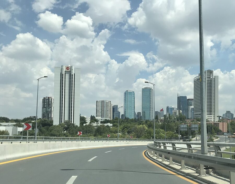 Highway with tall buildings in the background, showcasing the urban landscape of Söğütözü, Ankara.
