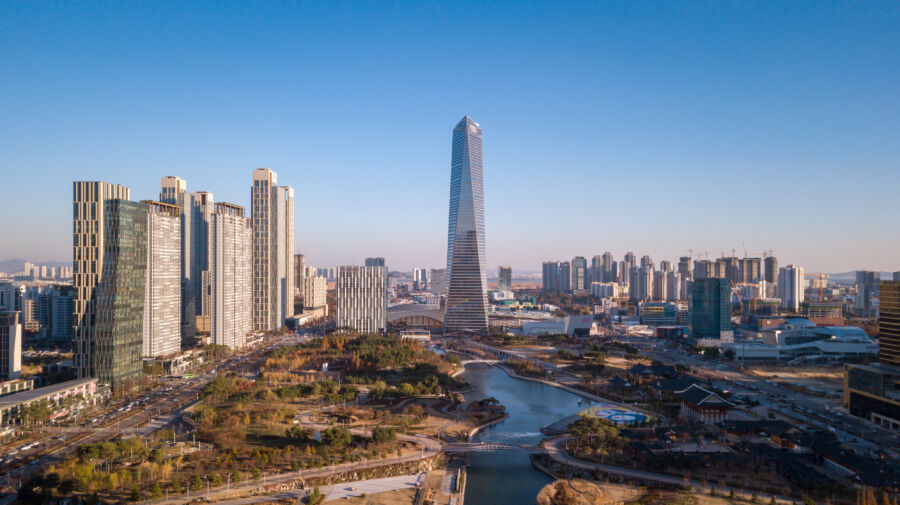 Cityscape of Songdo Central Park in Incheon, South Korea, featuring green spaces and modern architecture against a skyline