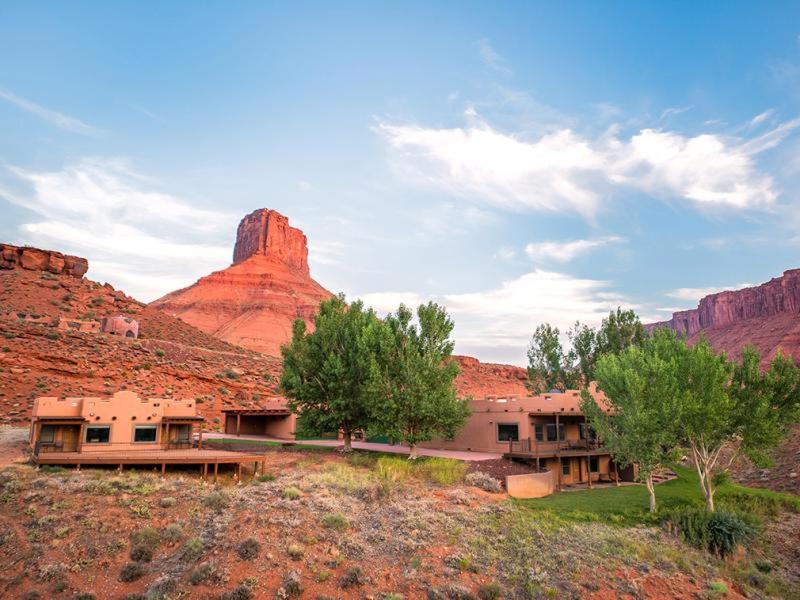 Sorrel River Ranch Resort and Spa features a spacious house surrounded by desert landscape and a mountain in the distance.