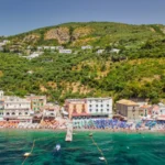 Aerial view of Marina del Cantone Beach, showcasing its turquoise waters and surrounding cliffs along the Amalfi Coast, Italy