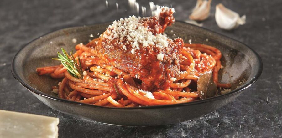 Spaghetti in rich tomato sauce with meat, cheese, rosemary, and garlic; classic Italian dish.