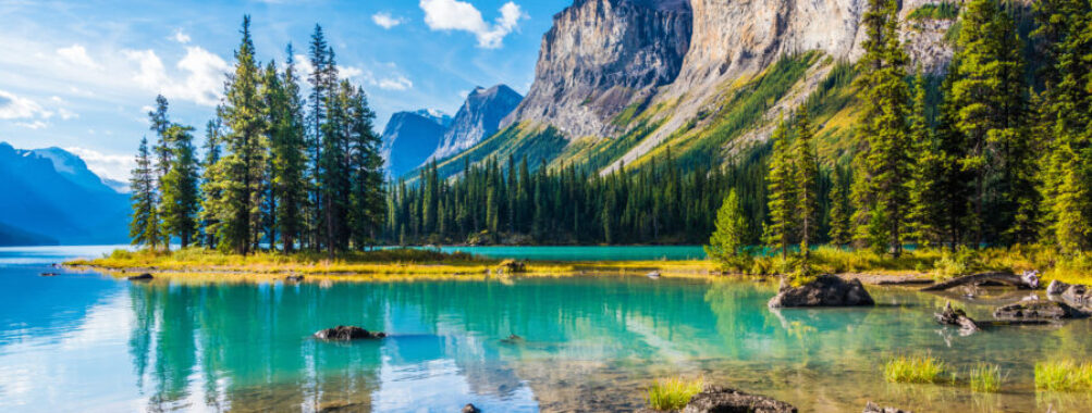 Scenic view of Spirit Island on Maligne Lake, surrounded by mountains in Jasper National Park, Alberta, Canada.