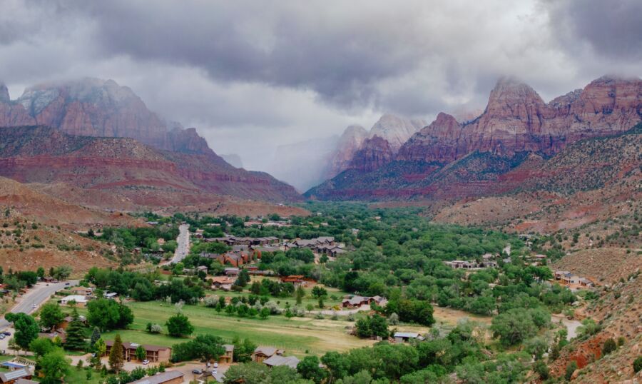 Scenic view of Springdale with lush green trees and the majestic mountains of Zion National Park in Utah