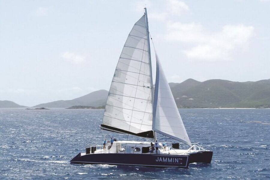 Catamaran sailing in the open ocean, part of the St. John Days End Sunset Sail, featuring an open bar and hors d'oeuvres.