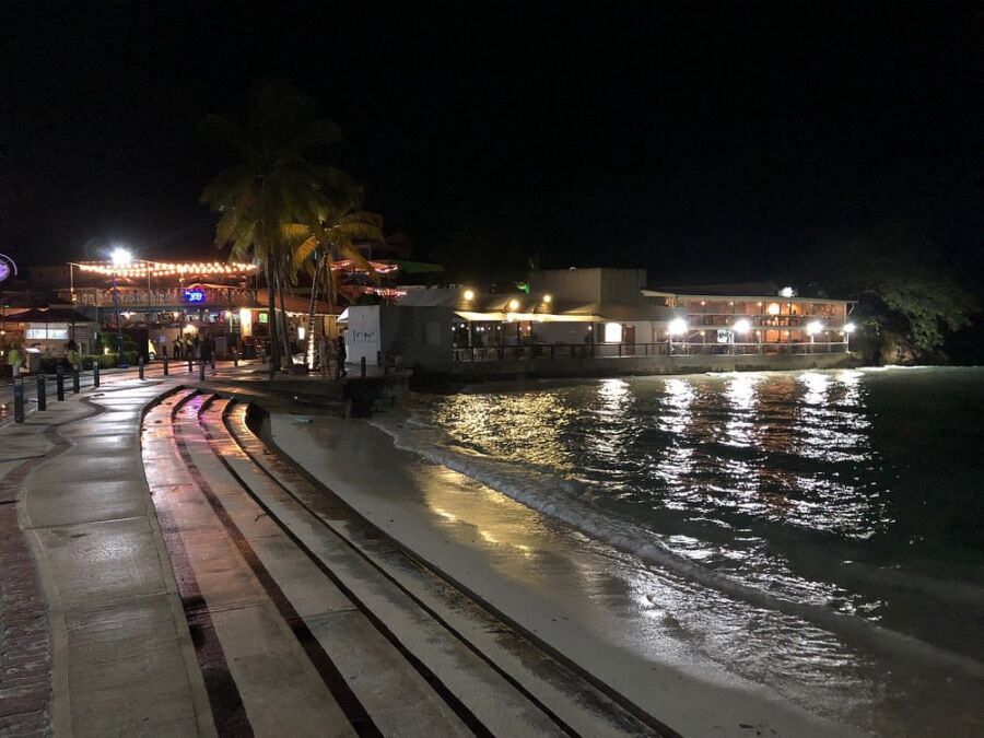 Night view of St. Lawrence Gap in Barbados, showcasing vibrant nightlife, illuminated buildings, and bustling streets