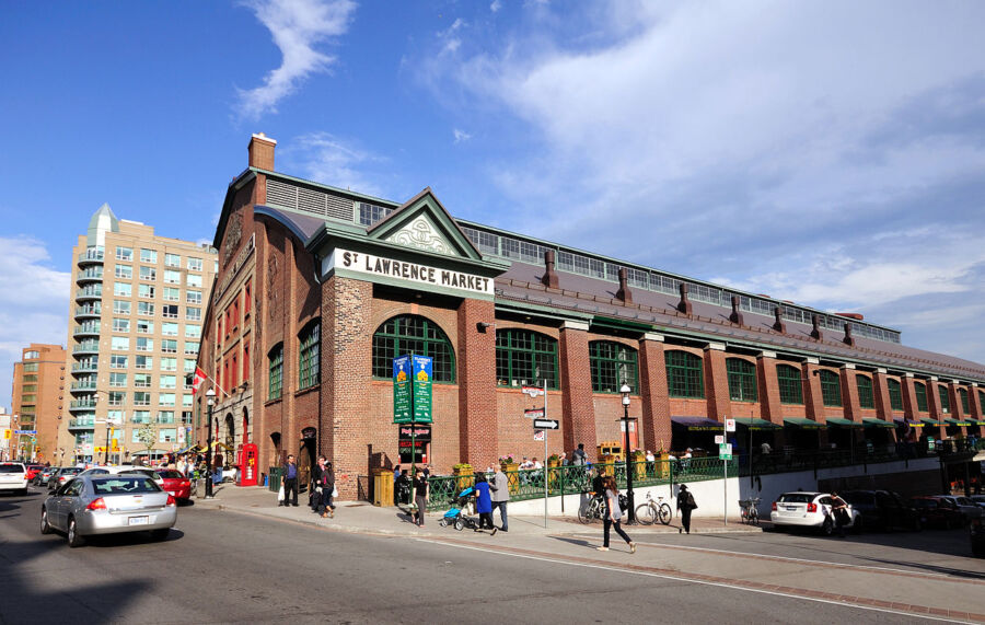 St. Lawrence Market in Toronto features a prominent large building with a clock on its side.
