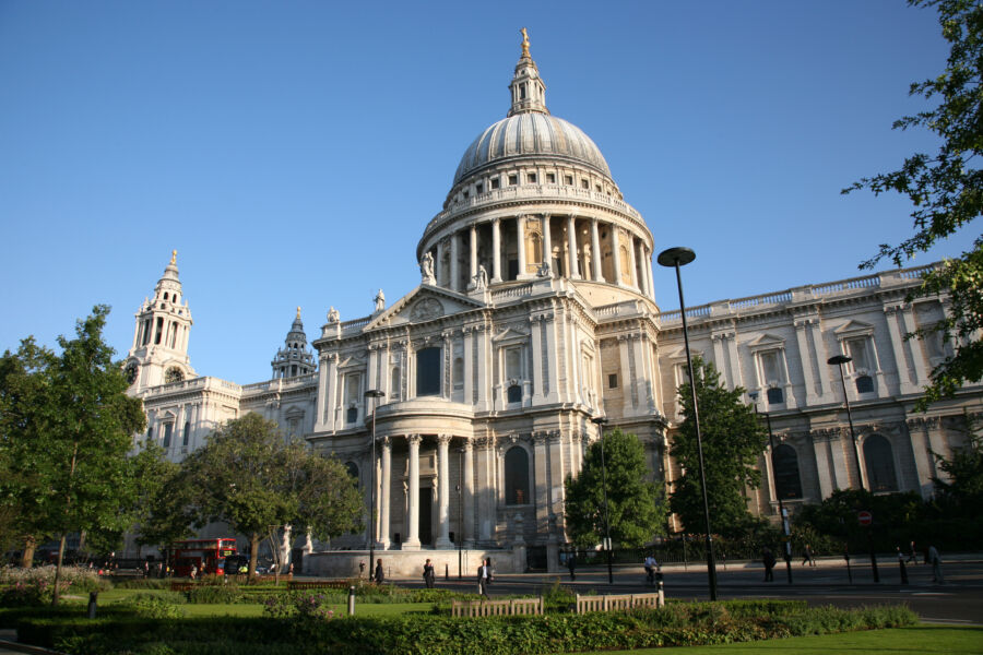 Exterior view of St. Paul's Cathedral with a backdrop of London's skyline