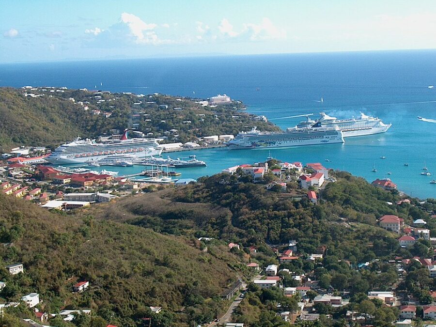 Large cruise ships at the harbor in St. Thomas, US Virgin Islands, surrounded by the quaint town scenery.