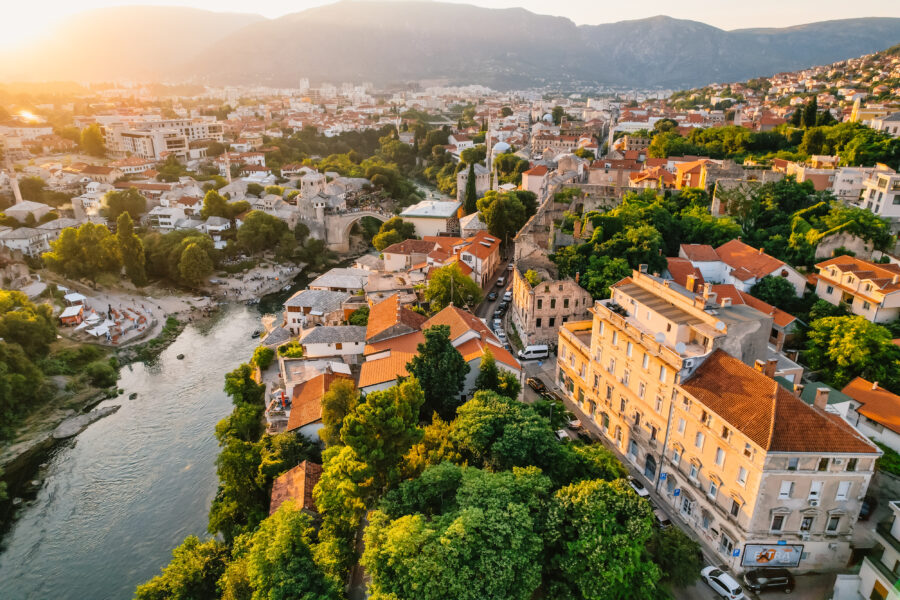 The iconic Stari Most, or Old Bridge, spans the Neretva River in Mostar, Bosnia and Herzegovina, showcasing historic architecture.
