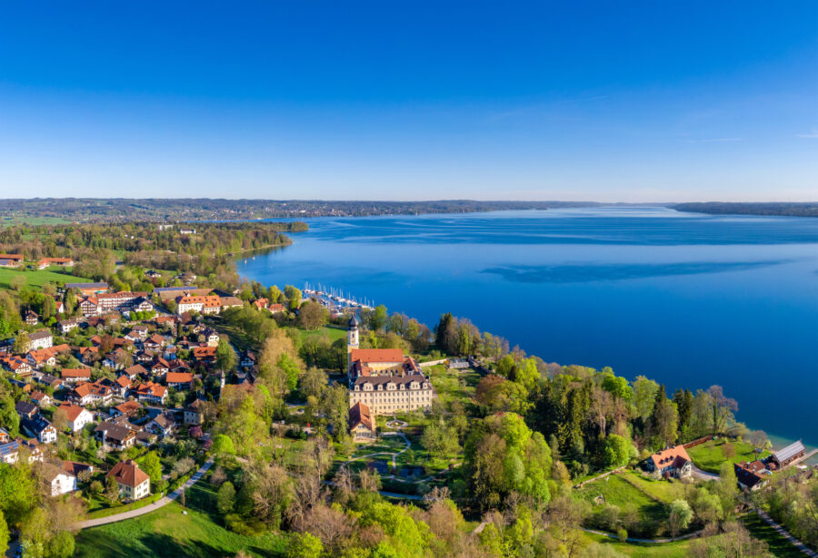 Scenic view of Bernried village by Lake Starnberg, showcasing lush greenery and tranquil waters in Bavaria, Germany.
