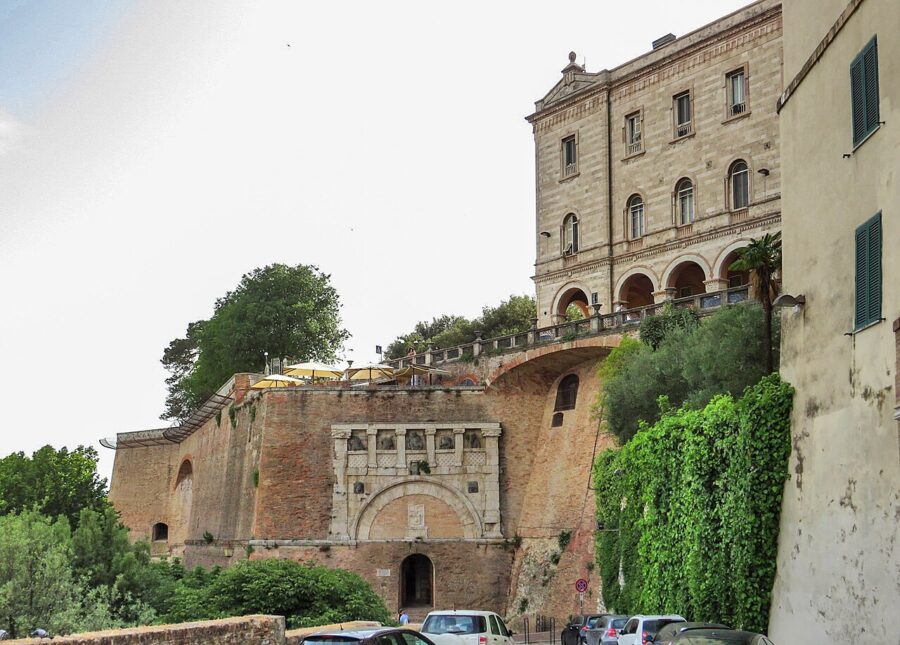Rocca Paolina Perugia stone terrace with arched portal and ivy-covered wall.