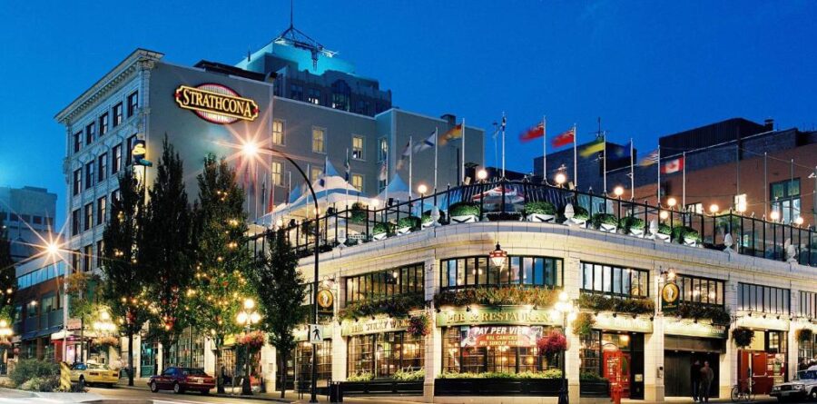 Strathcona Hotel in Victoria, BC, featuring a large building with a prominent sign on the front.