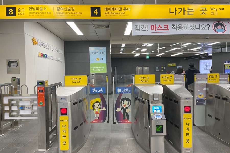 Subway station exit gates and turnstiles with Way Out signs and accessibility access, Seoul.