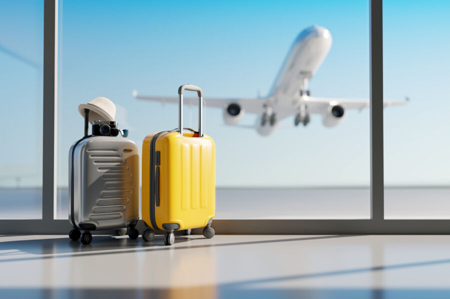 Small suitcases positioned at an airport, showcasing various colors and designs for travelers