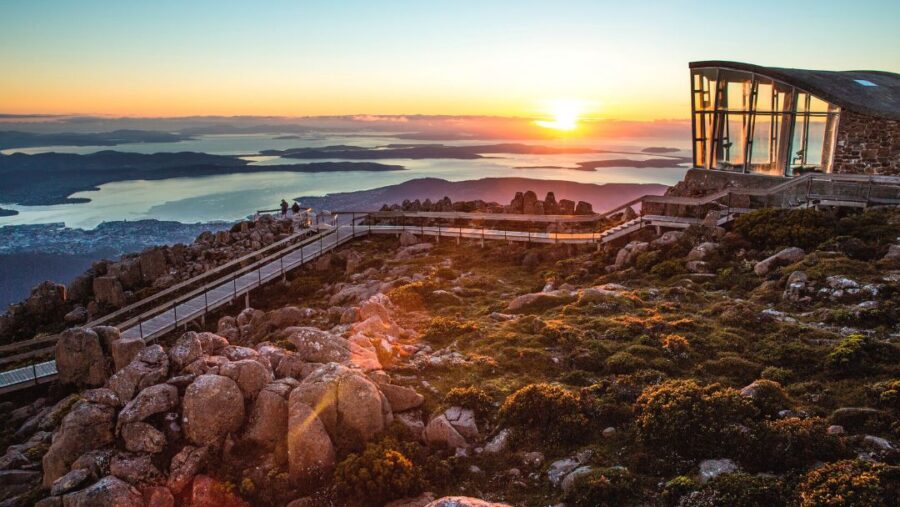 Sunrise mountain lookout boardwalk on Mount Wellington overlooking coastal islands, ocean, and scenic horizon.