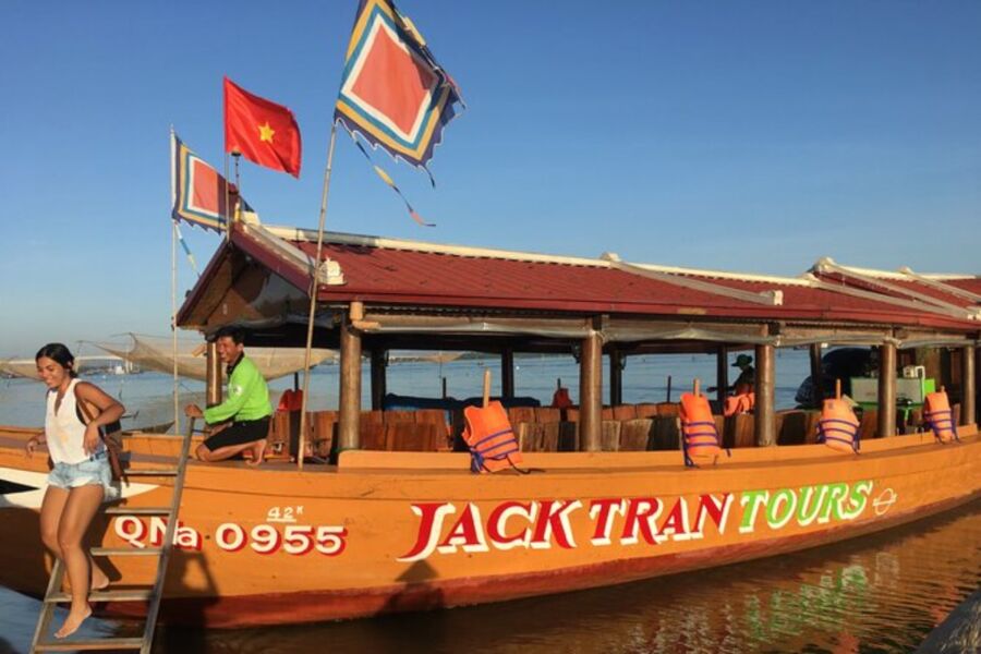 Scenic view of a jack train tour in Hoi an, showcasing the vibrant sunset over the river and surrounding landscape.

