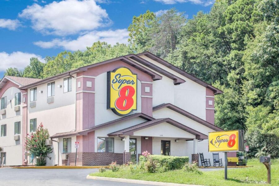 Super 8 by Wyndham motel nestled in the mountains of Roanoke, VA, featuring a welcoming exterior and scenic surroundings.