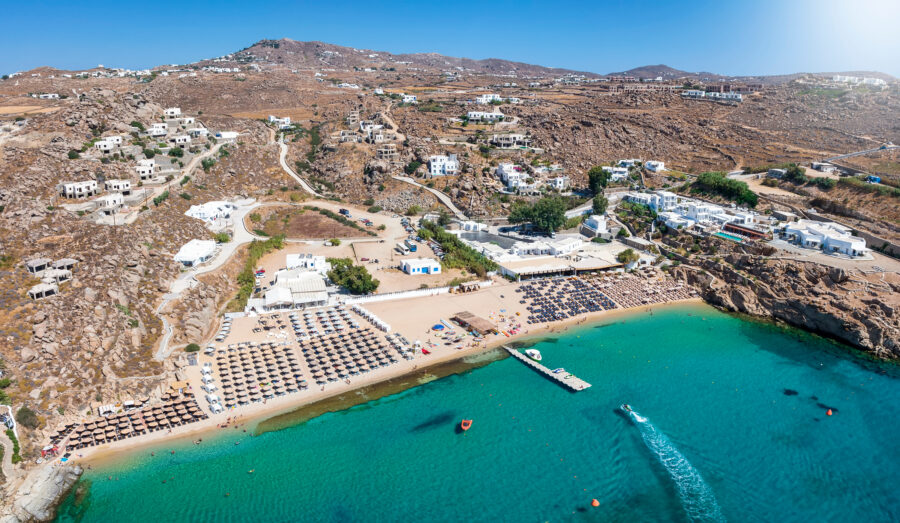 Aerial view of Super Paradise Beach in Mykonos, showcasing golden sands and turquoise waters on a sunny summer day