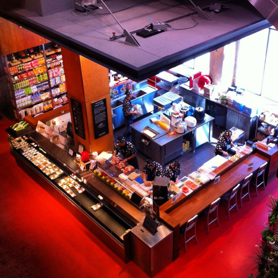Aerial view of a sushi bar at Loblaw's MLG in Toronto, showcasing the restaurant's layout and seating arrangement.