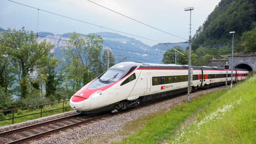 High-speed train in picturesque landscape, showcasing modern rail technology and natural beauty.