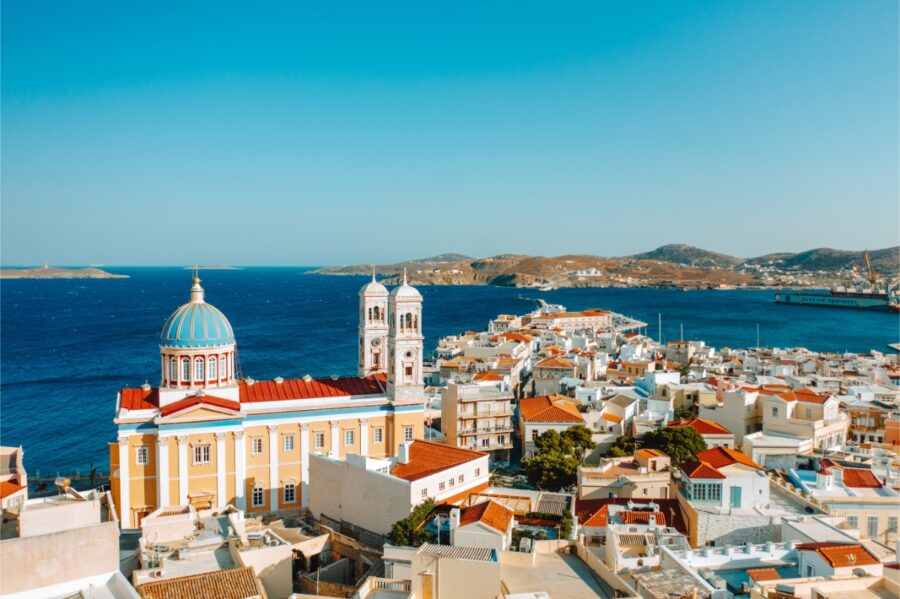 Aerial panoramic view of Ermoupolis, showcasing the vibrant architecture and coastline of Syros island, Greece.