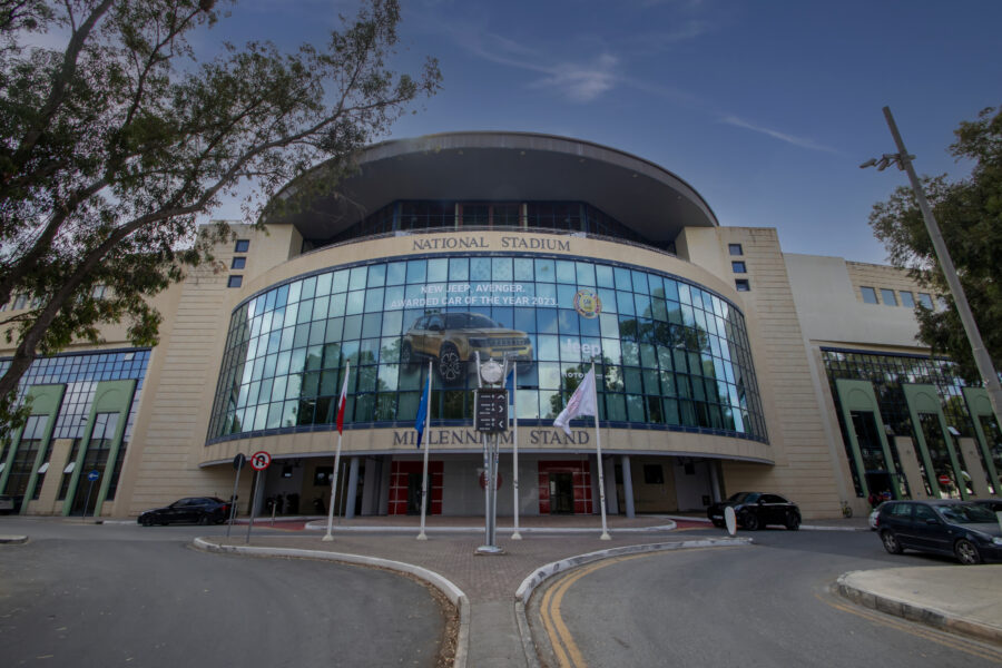 Exterior of Ta Qali National Stadium highlighting its impressive design and spacious entrance area.