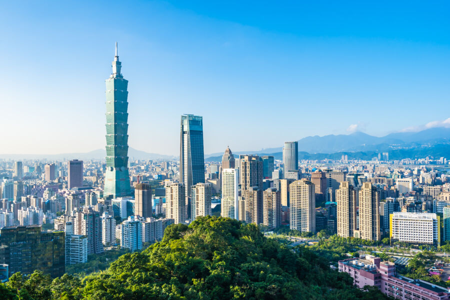 Scenic landscape of Taipei, Taiwan, featuring a blend of modern skyscrapers and natural greenery against a bright sky