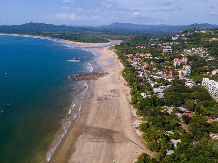 Aerial view of Tamarindo Beach and Town in Guanacaste, Costa Rica, showcasing sandy shores and vibrant coastal scenery