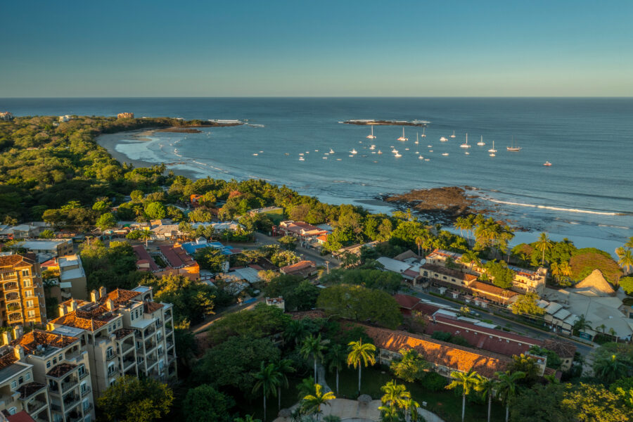 Aerial view of Tamarindo Beach, Costa Rica, showcasing the town and bay with lush greenery and sandy shores