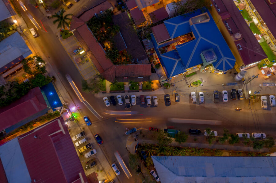 Aerial view of parked cars in Tamarindo, Costa Rica, illuminated by streetlights at night