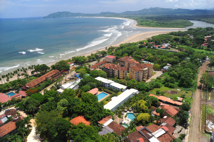 Aerial perspective of Tamarindo, Costa Rica, highlighting resorts nestled along the vibrant coastline and surrounding nature