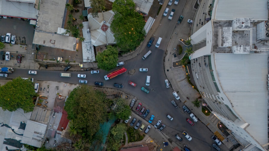 Aerial view of a busy intersection in Tamarindo, Costa Rica, showcasing traffic and surrounding buildings