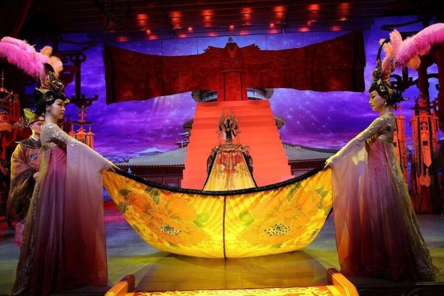 Two women in traditional costumes perform a dance from the Xian Tang Dynasty show, showcasing cultural artistry and elegance.

