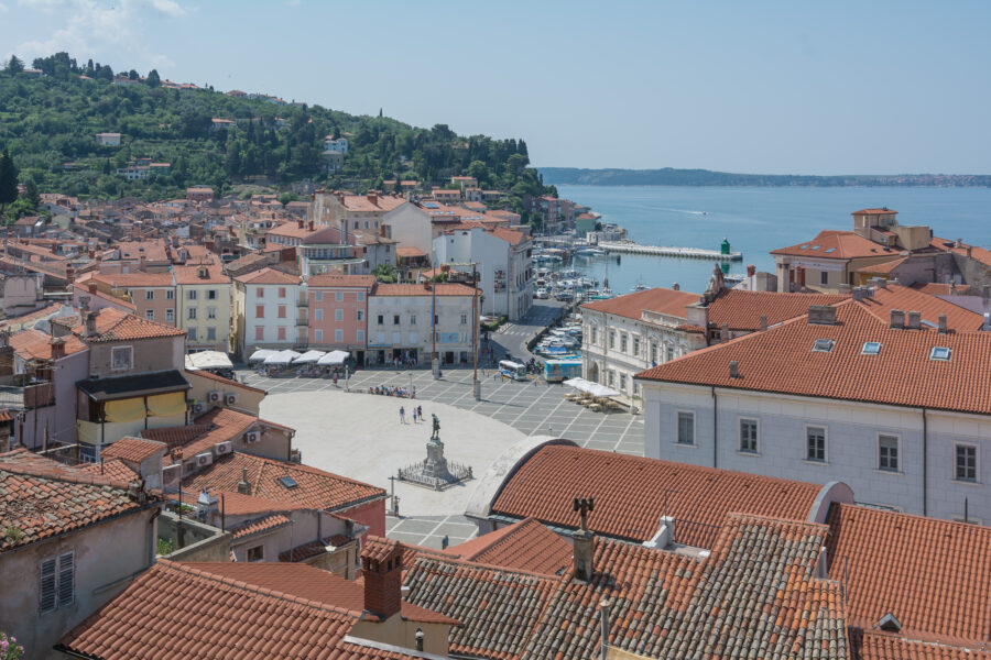 Scenic view of Tartini Square, Piran, Slovenia, featuring charming buildings and lively atmosphere in the city center.