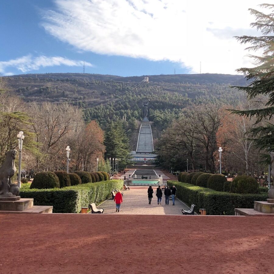Scenic view of Vake Park in Tbilisi, Georgia, with lush greenery and mountains in the background.