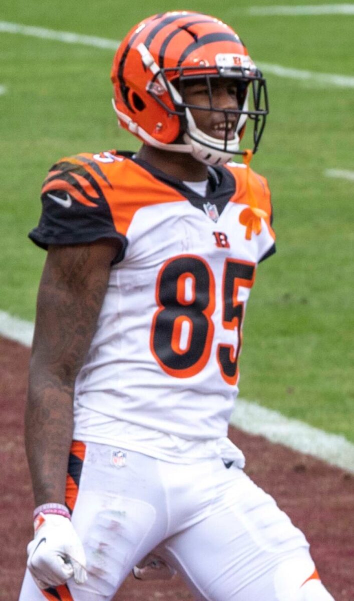 Tee Higgins, a professional football wide receiver, is shown in action during a game, wearing his team's uniform