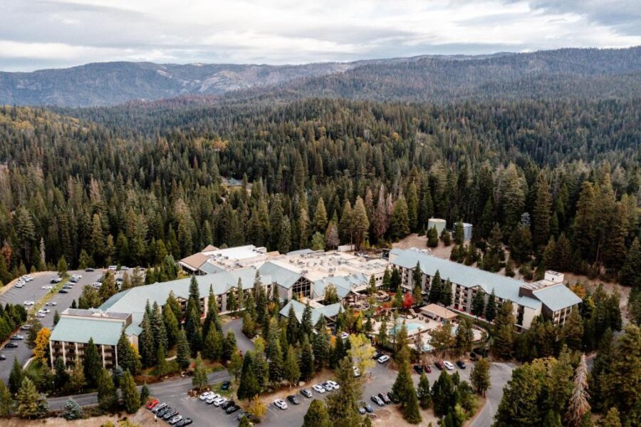 Scenic aerial view of Tenaya at Yosemite, showcasing the resort surrounded by majestic mountain landscapes.
