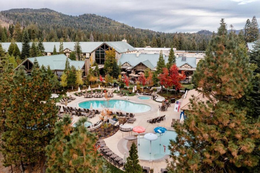The resort at Lake Tahoe, Tenaya at Yosemite, is nestled among lush green trees, creating a serene natural setting.