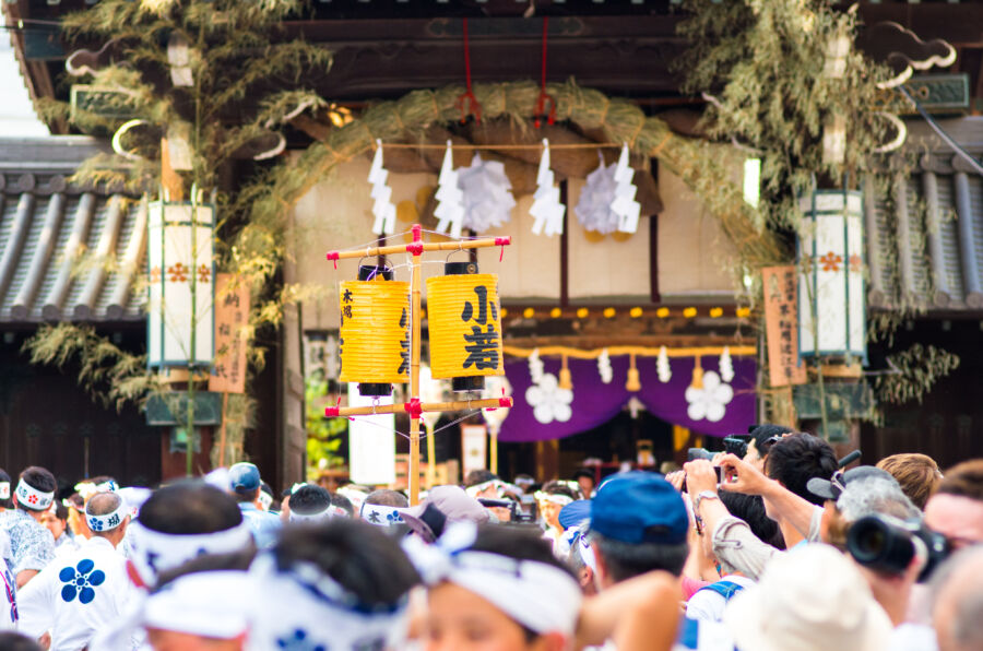 Colorful parade at Tenjin Matsuri festival in Osaka, Japan, featuring traditional costumes and festive decorations