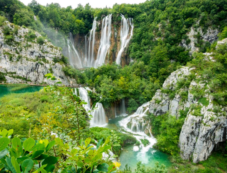 Plitvice Lakes waterfalls cascading into terraced turquoise pools in Croatia.