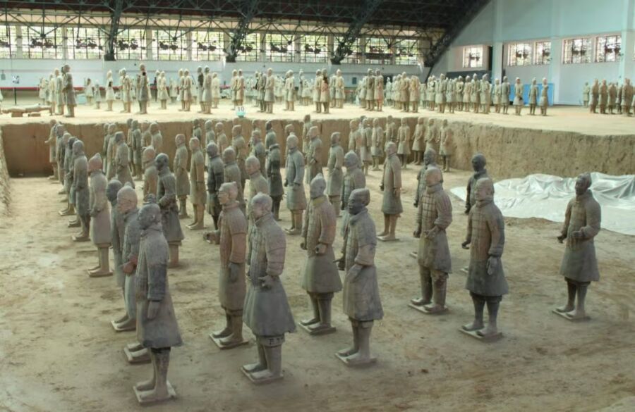 Numerous Terracotta Warriors arranged in a museum, representing the historical figures from ancient Xi'an, China.
